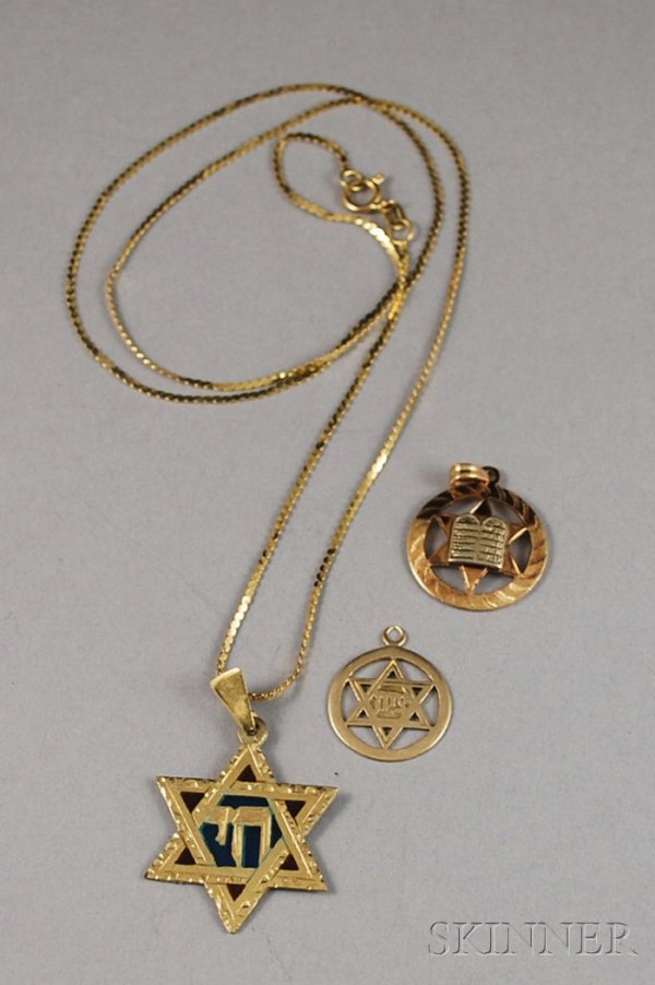 Three 14kt Gold Star of David Pendants, one on a 1: Three 14kt Gold Star of David Pendants, one on a 14kt gold chain, total 3.4 dwt.