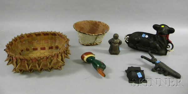 Seven Assorted Decorative and Collectible Items, a: Seven Assorted Decorative and Collectible Items, a cast iron beetle-form bootjack, a cast iron lamb mold, a painted "Mammy" still bank, a wall match safe, Northeast woven splint basket and birch bark
