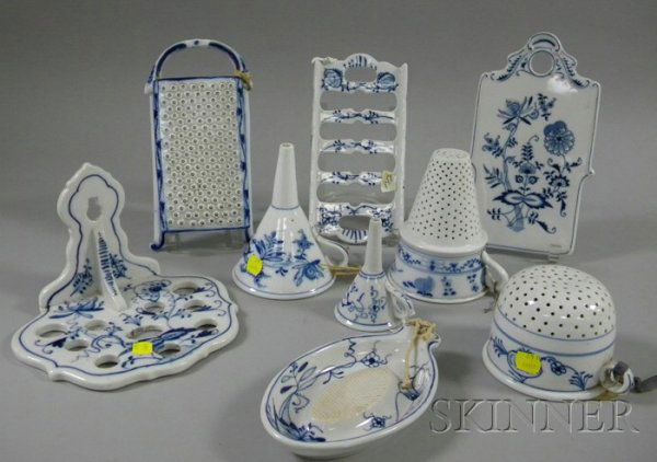 Nine German Blue and White Meissen-type Decorated: Nine German Blue and White Meissen-type Decorated Porcelain Kitchen Items, two graters, two strainers, a bread trivet, two funnels, a cutting board, and a utensil rack, including Blue Onion pattern.