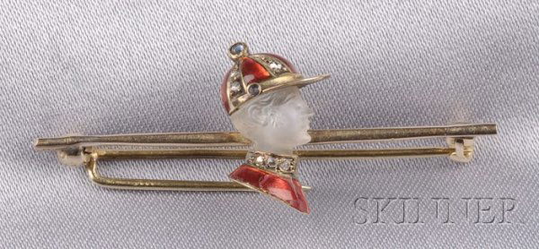 14kt Gold, Carved Moonstone and Enamel Jockey Pin: 14kt Gold, Carved Moonstone and Enamel Jockey Pin c. 1910, the carved moonstone head with red enamel and rose-cut diamond cap and colors, 5/8 x 1 3/4 in.