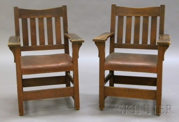 Pair of Gustav Stickley Armchairs Oak, leather, bra: Pair of Gustav Stickley Armchairs Oak, leather, brass New York, 1907-1912 V-back over five vertical slats, flat arm with through post, leather seats with brass tacks, single front and two side stretch