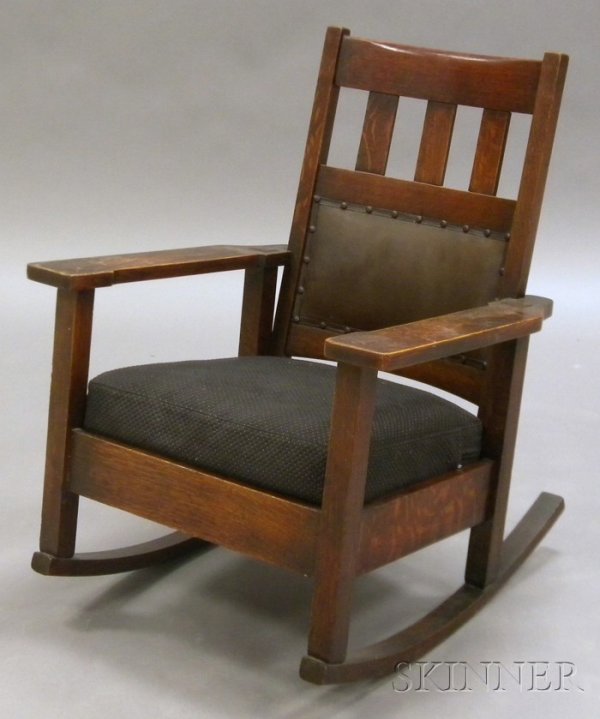 Arts & Crafts Rocking Chair Oak United States, ear: Arts & Crafts Rocking Chair Oak United States, early 20th century Curved crest rail over three vertical slats, lower seat back upholstered, shaped arms with through tenons, upholstered cushion seat, h