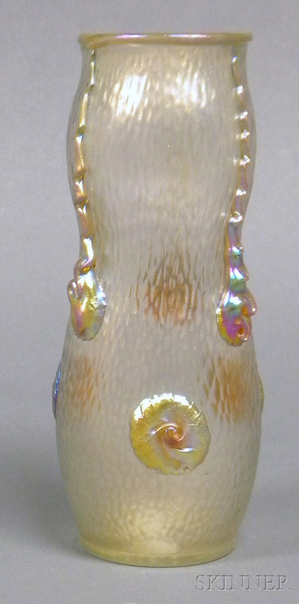 Vase, Possibly Loetz Iridescent and decorated art : Vase, Possibly Loetz Iridescent and decorated art glass Bohemia, early 20th century Cylindrical, shaped form with applied gold iridescent rim, trailing decoration and nautilus-style prunts on dimpled 