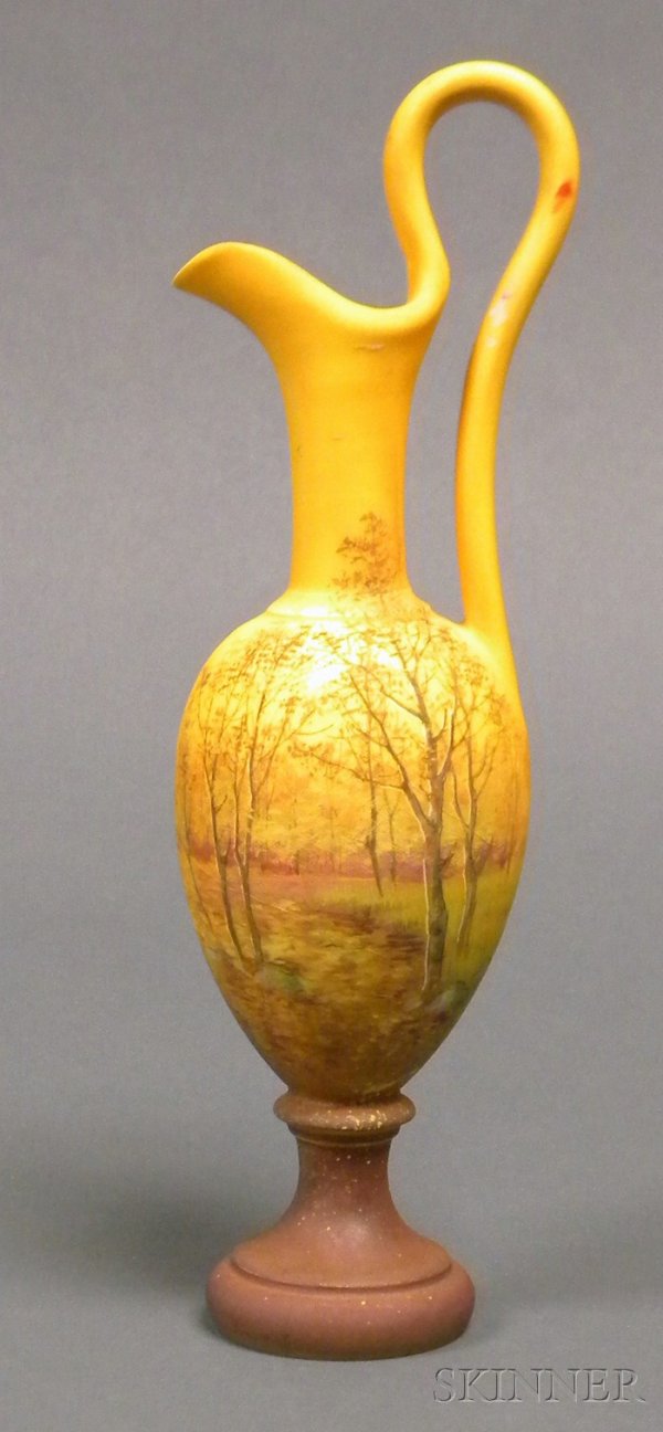 Delphin Massier Ewer Hand-painted earthenware Fran: Delphin Massier Ewer Hand-painted earthenware France, 1836-1907 Pitcher form with long loop handle, decorated with an autumn landscape against an orange ground, brown foot, signed Delphin Massier Vall