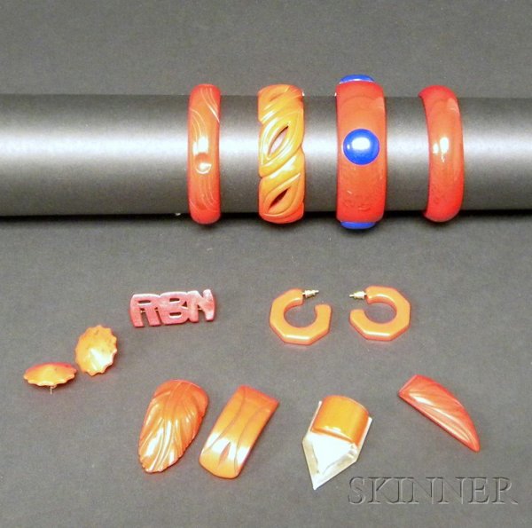 Ten Bakelite Jewelry Items All in red, four bangle: Ten Bakelite Jewelry Items All in red, four bangles including two carved and one with raised blue dots; two pairs of post-back earrings; RBN initial pin; three carved clips, one geometric with polishe