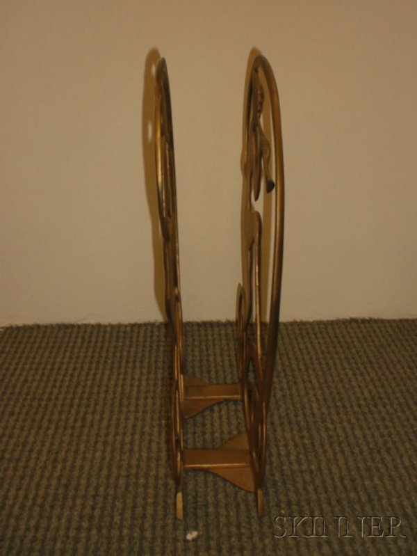 Seville Art Metal Studios Magazine Rack Patinated : Seville Art Metal Studios Magazine Rack Patinated metal Cleveland, Ohio, c. 1928 Two nude figures dancing and playing the flute comprise the sides, adjusts for width, with stamped studio mark, copyrig