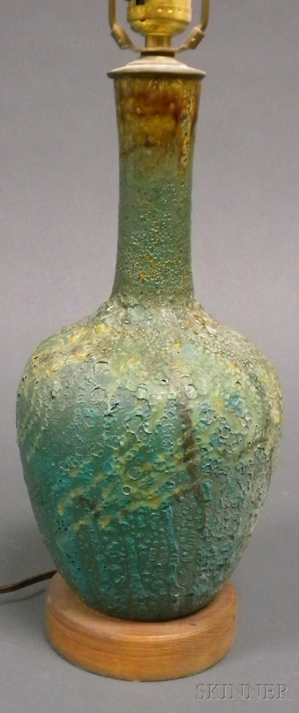 Pottery Table Lamp Glazed earthenware and metal Mi: Pottery Table Lamp Glazed earthenware and metal Mid-20th century Long neck on tapering bulbous base in volcanic turquoise glaze fitted with a single socket, turned wood base, ht. 28 in.