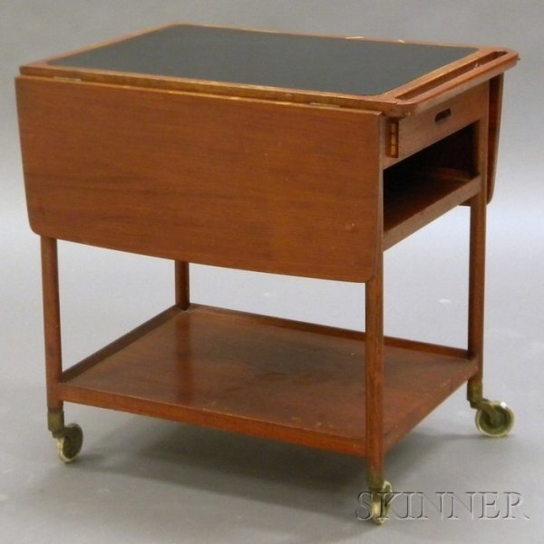 L. Pontoppidan Tea Cart Teak and laminate Kopenhav: L. Pontoppidan Tea Cart Teak and laminate Kopenhavn, Danmark, mid-20th century Rectangular top with black laminate insert, two drop-down leaves, single drawer over two shelves on rollers, manufacturer