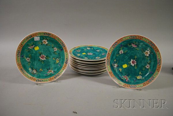 Set of Twelve Chinese Dinner Plates, featuring a f: Set of Twelve Chinese Dinner Plates, featuring a floral design on a green ground and a polychrome border, dia. 10 1/4 in., (nicks, scratches, some paint loss).