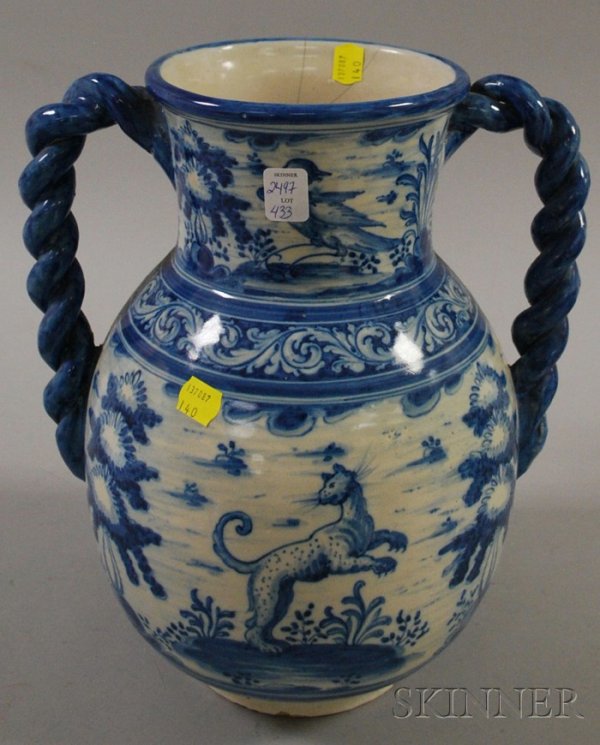 Large Blue and White Faience Two-handled Jar, mark: Large Blue and White Faience Two-handled Jar, marked "Tavera?" on the foot, with scenes of figures and wild animals, ht. 13 in., (cracks, chips to handles and foot).