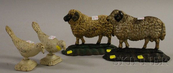 Two Painted Cast Iron Sheep Doorstops and Two Pai: Two Painted Cast Iron Sheep Doorstops and Two Painted Cast Iron Bird Figures.