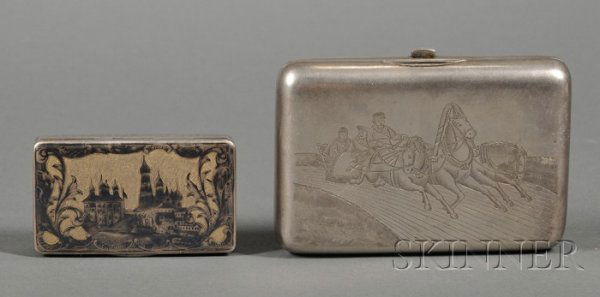 Two Russian Silver Tobacco Boxes, Moscow, a snuff: Two Russian Silver Tobacco Boxes, Moscow, a snuff box, 1849, maker's mark Be, niello decorated, lid and base engraved with scenes of a castle or cathedral against gold-washed ground, wd. 2 5/8; and a