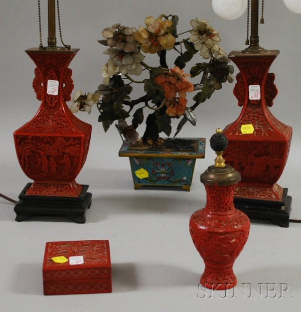Four Chinese Cinnabar Items and a Carved Hardstone: Four Chinese Cinnabar Items and a Carved Hardstone Flowering Tree in a Cloisonne Planter, including a pair of vase/table lamps, a small box, and a vase, (lamps with scattered chips,segment losses, and