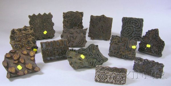 Lot of Decorative Asian Objects, including thirtee: Lot of Decorative Asian Objects, including thirteen Indian printing blocks, patterned, with hand mounts; four small Thai bronze amulets, mounted and framed; herd of carved wooden elephants, and a Chin