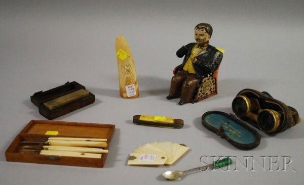 Eight Miscellaneous Items, a painted cast iron me: Eight Miscellaneous Items, a painted cast iron mechanical Tammany Bank, a pair of mother-of-pearl opera glasses, a carved faux whale's tooth, a vintage pocketknife, a Mexican silver spoon, a 19th cent