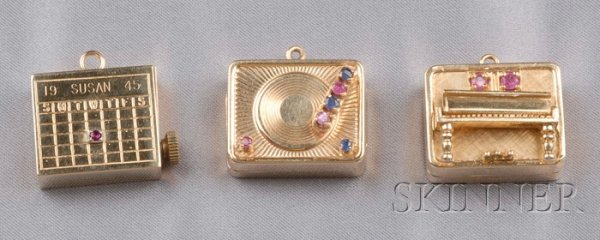 Three 14kt Yellow Gold Musical Charms, a piano, a : Three 14kt Yellow Gold Musical Charms, a piano, a record player, and a calendar, 33.7 dwt, (stem on the calendar charm not gold).