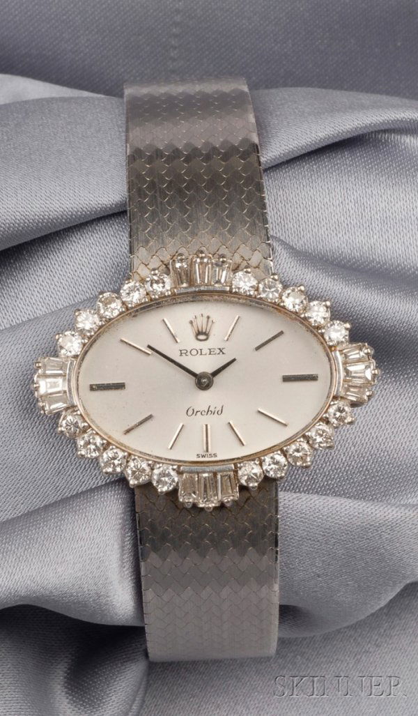 18kt White Gold and Diamond Wristwatch, Rolex, "Or: 18kt White Gold and Diamond Wristwatch, Rolex, "Orchid", the silver-tone dial with abstract numeral indicators, bezel set with diamond melee and baguettes, enclosing manual wind movement, completed by