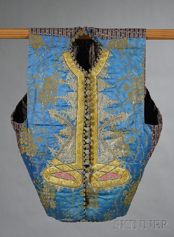 Vest, Turkey, embroidered flowers and geometric des: Vest, Turkey, embroidered flowers and geometric designs on a blue ground. lg. 22 in.