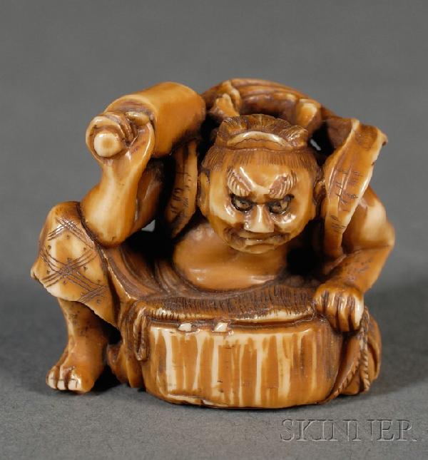 Ivory Netsuke, Japan, 19th century, carved as a se: Ivory Netsuke, Japan, 19th century, carved as a seated blacksmith, holding a tool in his right hand, signed "Tomoshi," ht. 1 1/8 in.