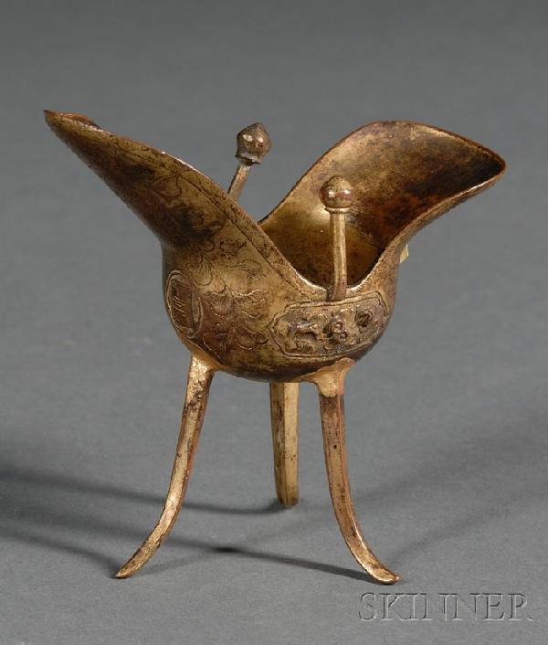 Shakudo Cup, Japan, 18th century, cast in the form: Shakudo Cup, Japan, 18th century, cast in the form of an archaic ritual bronze jue, the feet slightly curved upwards, cast separately and melded to the body, finely chased around the exterior with peo