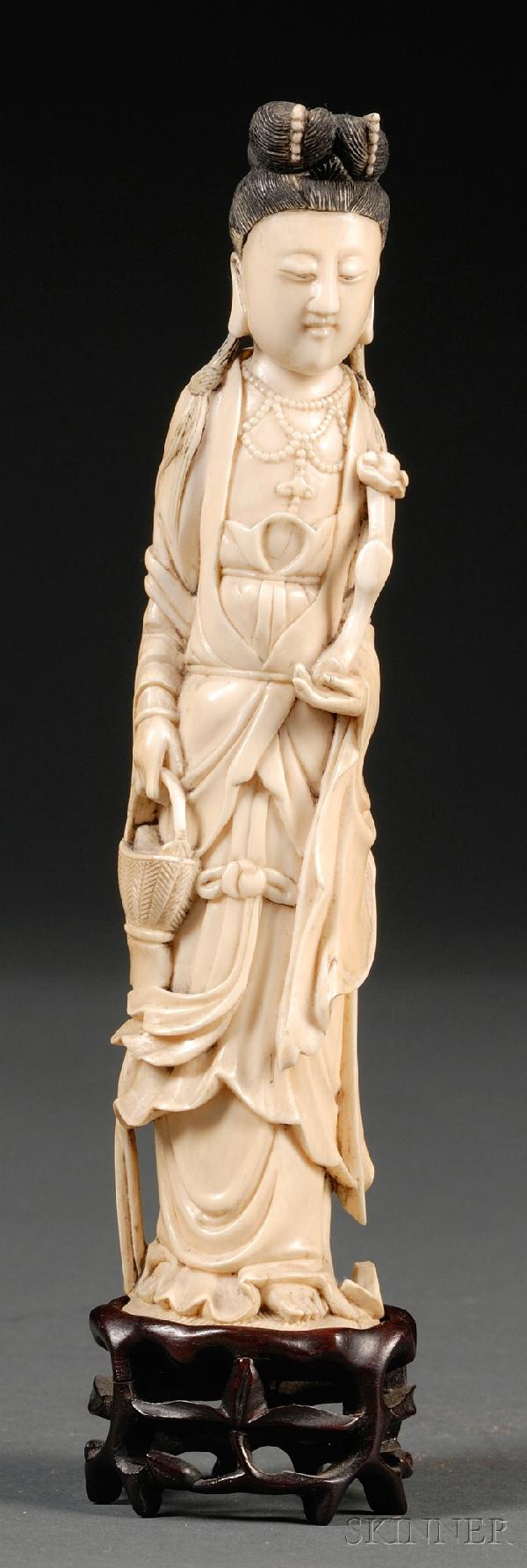Ivory Carving, China, 19th century, standing figur: Ivory Carving, China, 19th century, standing figure of Guanyin holding a basket in her right hand and a ruyi scepter in her left, wood stand, ht. 8 1/8 in.