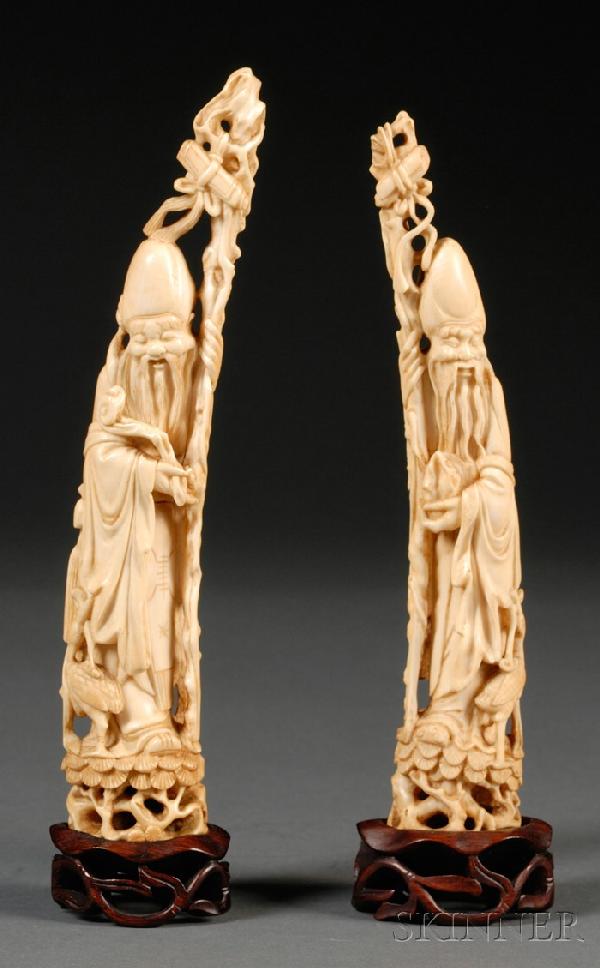 Pair of Ivory Carvings, China, 19th century, figur: Pair of Ivory Carvings, China, 19th century, figure of Shou Lao standing on a rockwork, holding a walking stick in one hand and an auspicious object in the other, accompanied by a crane holding a ruyi