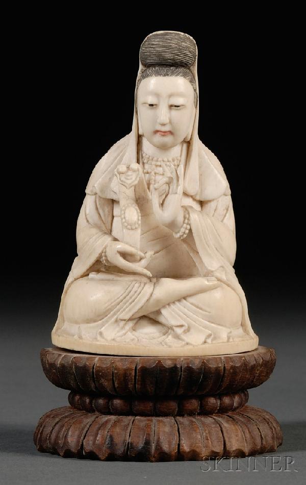 Ivory Carving, China, carved as seated Guanyin in : Ivory Carving, China, 19th century, carved as seated Guanyin in dhyanasana posture, holding a ruyi scepter in her right hand, left hand in vitarka mudra, hair and face painted, double-lotus