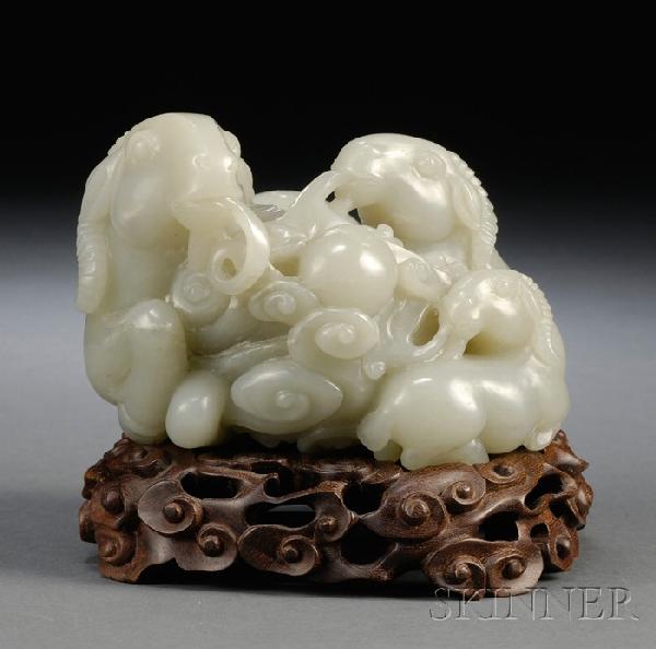 Celadon Jade Ram Group, San Yang Kai Tai, China, : Celadon Jade Ram Group, San Yang Kai Tai, China, 18th century, the ram carved with its young laying on its side, all holding in the mouth ribbons attached to a celestial ball, on a carved and pierced 