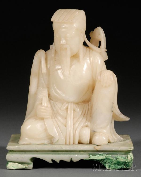 Soapstone Carving, China, seated figure of an off: Soapstone Carving, China, seated figure of an official, holding a whisk in his right hand, carrying a sword on the back, integral rectangular stand, ht. 6 1/8, 7 1/4 in. with stand.