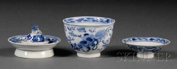 Blue and White Teacup, China, including cup, cove: Blue and White Teacup, China, including cup, cover, and stand, each painted in underglaze blue with foo dogs playing with brocade balls, ht. 3 in.
