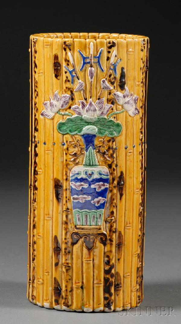 Porcelain Vase, China, 19th century, modeled in t: Porcelain Vase, China, 19th century, modeled in the shape of a deep bamboo basket, the front side with molded design of lotus blossoms and halberds in a hu vase, reserved on a yellow glazed ground wit