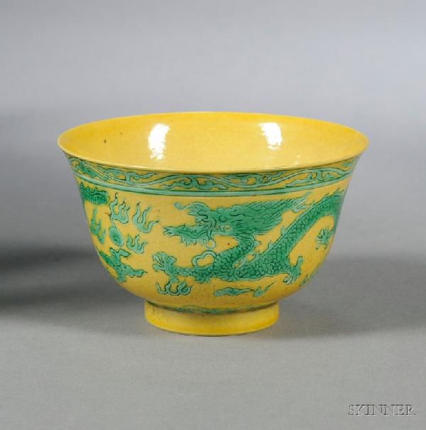 Dragon Bowl, China, green enameled dragons chasin: Dragon Bowl, China, green enameled dragons chasing flaming pearls on a yellow ground, all between a band of foliage scroll around the mouth rim and ruyi heads above the foot, with a shou medallion in