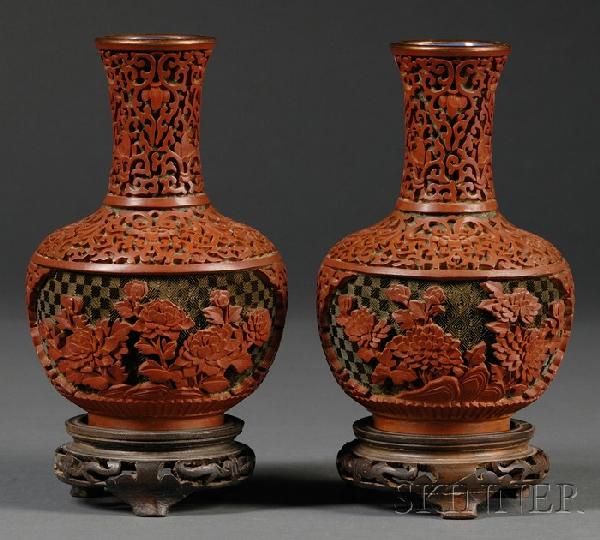 Pair of Carved Cinnabar Vases, China, of globular: Pair of Carved Cinnabar Vases, China, of globular shape, the exterior carved with two cartouches of herbaceous peony branches issuing from rockwork and reserved on a diaper ground, below a band of flo
