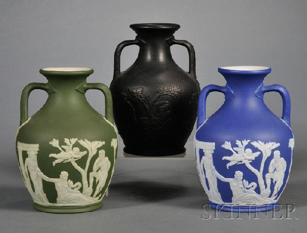 Three Wedgwood Portland Vases, England, 19th/20th c: Three Wedgwood Portland Vases, England, 19th/20th century, each with classical figures in relief, a black basalt; a dark blue jasper dip; and an olive green jasper dip; impressed marks ht. 5 3/4 in.