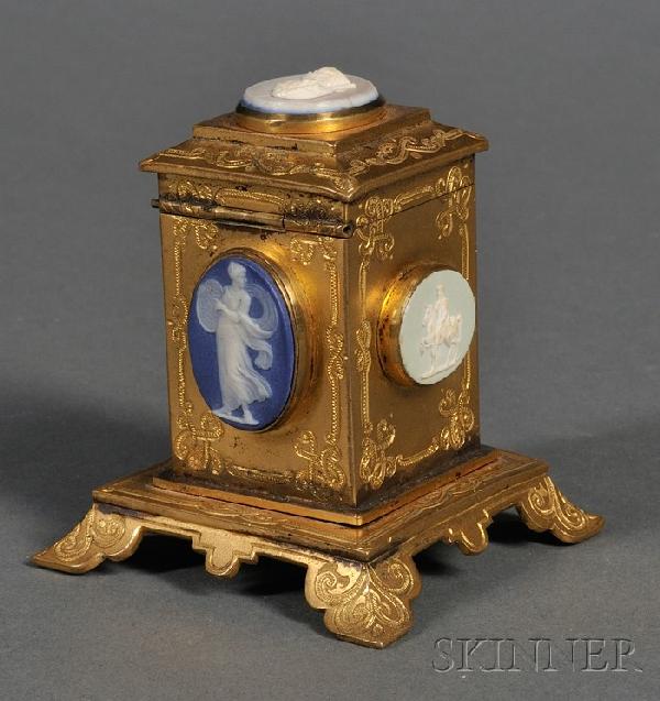 Wedgwood Mounted Ormolu Box, England, 19th century: Wedgwood Mounted Ormolu Box, England, 19th century, the raised rectangular box with incised and scrolled borders and hinged lid, each side and lid with an applied medallion, ht. 2 5/8 in.
