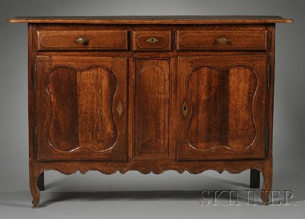 French Provincial Oak Buffet, 19th century, rectan: French Provincial Oak Buffet, 19th century, rectangular top and case fitted with three drawers and a pair of doors with shaped panels, on shaped cabriole legs, ht. 46 1/2, wd. 69, wd. 21 1/4 in.