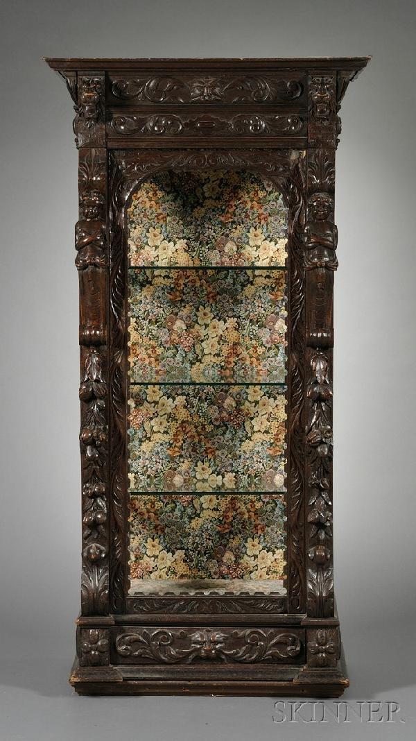 Renaissance Revival Carved Oak Display Cabinet, c.: Renaissance Revival Carved Oak Display Cabinet, c. 1880, molded cornice above a rectangular case carved in high relief with scrolling foliate, figural pilasters and fruit bunches, on molded plinth bas