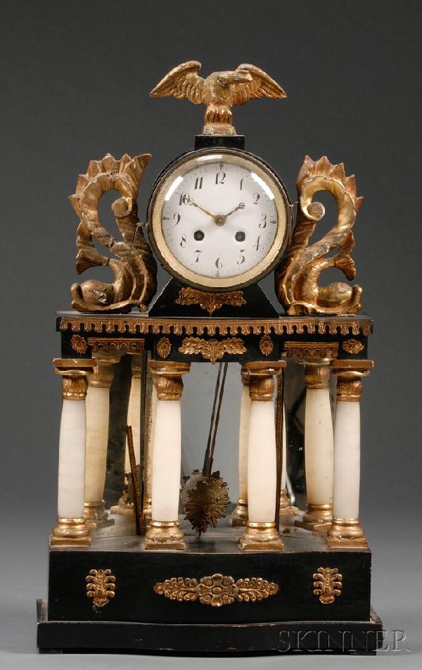 Biedermeier Ebonized, Parcel-gilt, Mirror, and Ony: Biedermeier Ebonized, Parcel-gilt, Mirror, and Onyx-mounted Mantel Clock, mid 19th century, the two-train, half-striking movement topped by a giltwood eagle and flanked by giltwood addorsed dolphins, 
