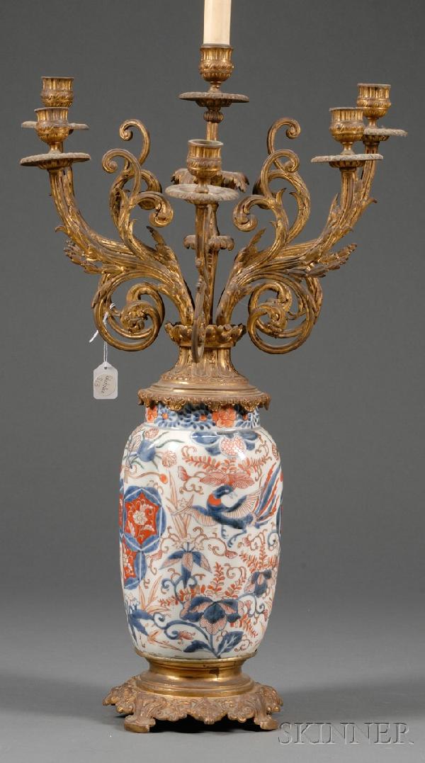 Ormolu Mounted Imari Porcelain Six Light Candelabr: Ormolu Mounted Imari Porcelain Six Light Candelabrum, late 19th century, with ovoid porcelain body with underglaze blue and iron red decoration of foliage, medallions, and birds in flight, mounted wit