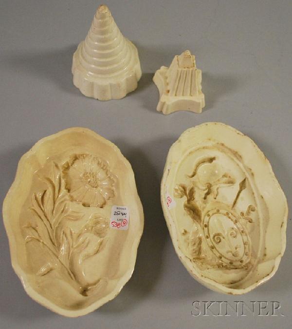 Four Wedgwood Creamware Culinary Molds, including: Four Wedgwood Creamware Culinary Molds, including floral, armorial, and two small geometric molds, (glaze wear, staining, small chips, hairlines).