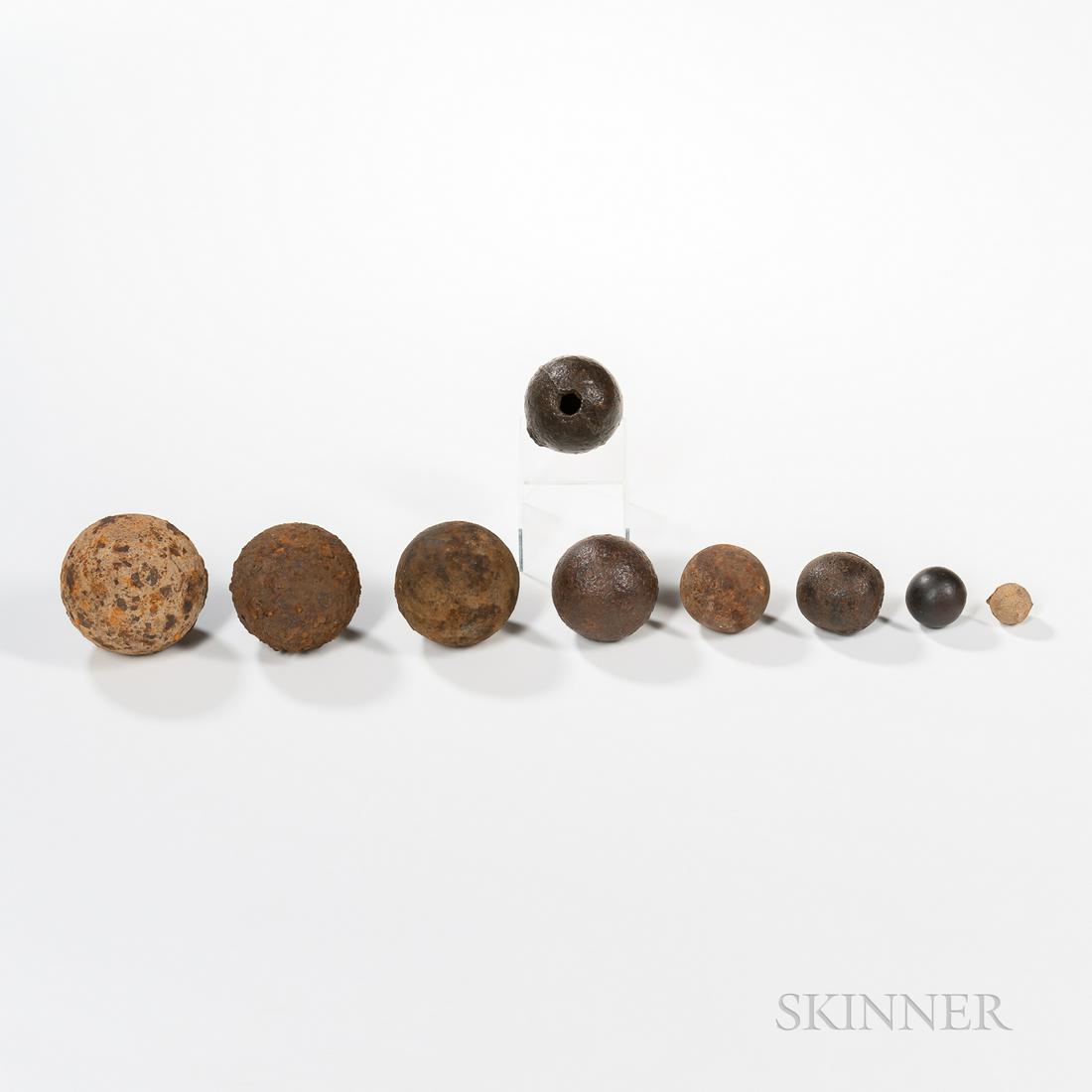 Eight Graduated Caliber Cannon Balls and a Grenade: Eight Graduated Caliber Cannon Balls and a Grenade, 18th/early 19th century, calibers include: 9-pounder, two 6-pounders including one with a broad arrow mark, 4-pounder with a broad arrow mark, 2-pou