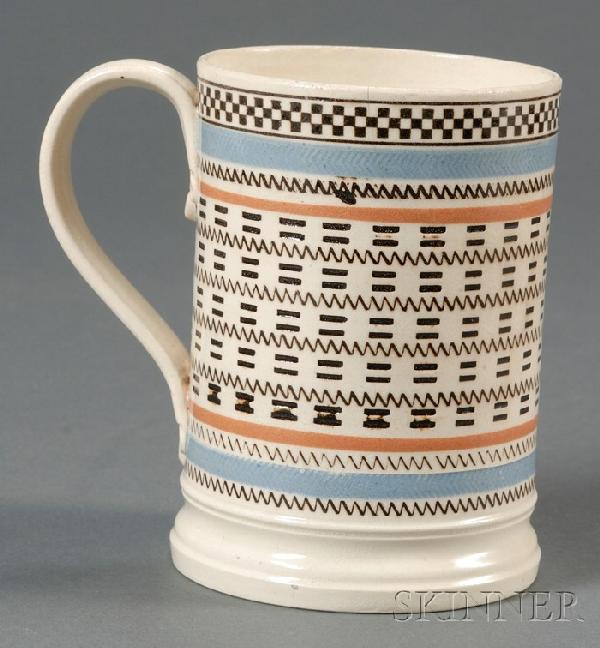 Mochaware Engine-turned Mug, pearlware pint mug ba: Mochaware Engine-turned Mug, pearlware pint mug banded in blue and rust, with black inlaid rouletting and engine-turning, ht. 4 7/8 in.