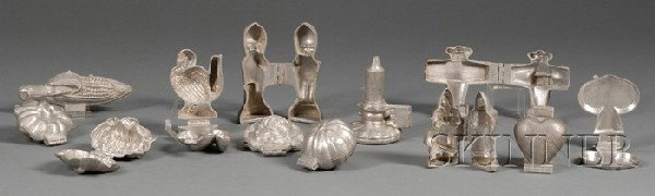 Twelve Pewter Chocolate Molds and a Candy Mold Man: Twelve Pewter Chocolate Molds and a Candy Mold Manufacturer's Catalogue, America, c. 1931, hinged molds featuring a Santa Claus, four flower blossoms, Kewpie Doll, airplane, turkey, ear of corn, candl