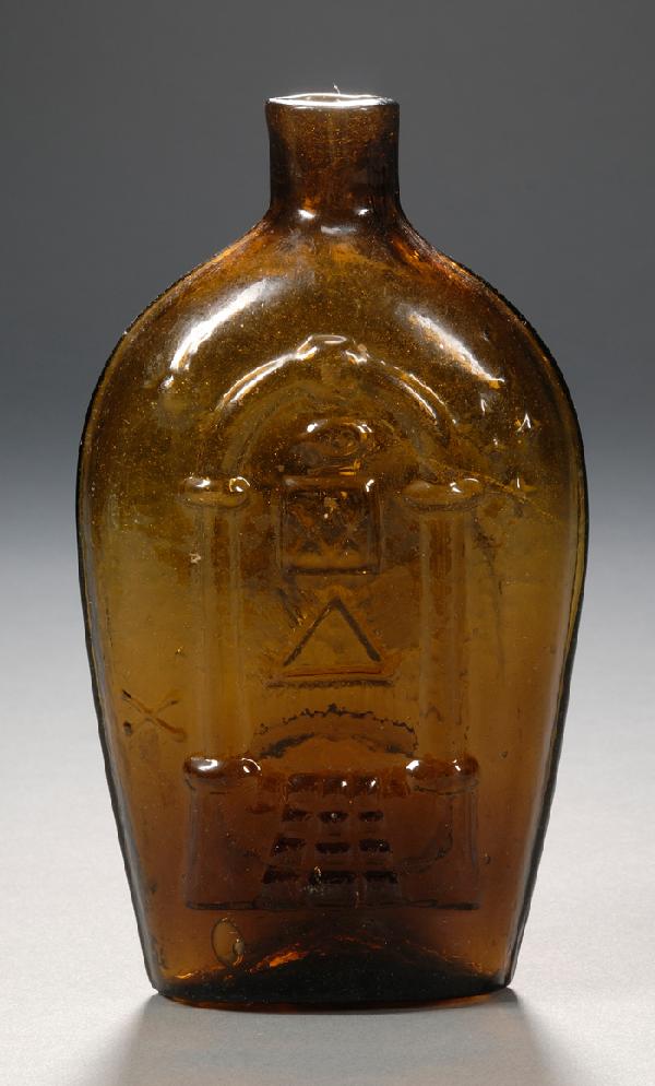 Amber Masonic/Eagle Glass Flask, Keene, New Hampsh: Amber Masonic/Eagle Glass Flask, Keene, New Hampshire, early 19th century, pint flask, one side with Masonic decoration, the reverse with a banner over an eagle with American shield and oval reserve i