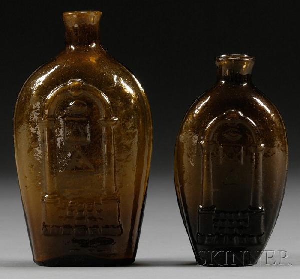 Two Amber Blown Molded Historical Masonic/Eagle Gl: Two Amber Blown Molded Historical Masonic/Eagle Glass Flasks, Keene Glassworks, Keene, New Hampshire, early 19th century, a pint flask with Masonic decoration on one side and an eagle over an oval res