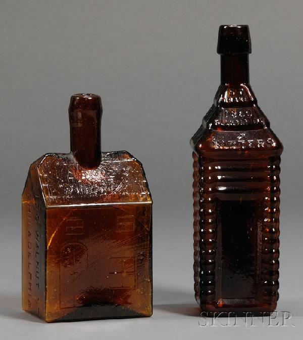 Two Amber Glass Cabin-form Bitters Bottles, Americ: Two Amber Glass Cabin-form Bitters Bottles, America, 1860-80, an orange amber St. Drake's bottle, tall four-log example with applied tapered lip, raised lettering "ST. DRAKE'S 1860 PLANTATION X BITTER