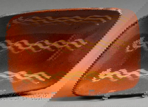 Slip Decorated Redware Loaf Dish, America, early 1: Slip Decorated Redware Loaf Dish, America, early 19th century, oblong dish with yellow slip "bacon strip" decoration, (rim chips), ht. 1 3/4, wd. 8, lg. 11 3/4 in.