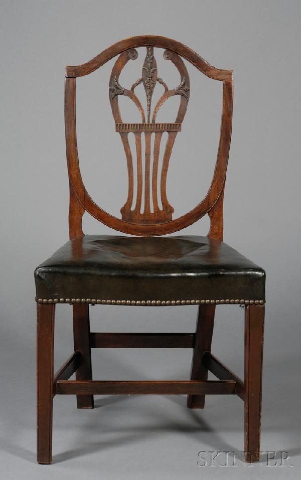 Hepplewhite Carved Mahogany Shield-back Side Chai: Hepplewhite Carved Mahogany Shield-back Side Chair, England, early 19th century, the splat carved with Prince of Wales feathers and floral devices, (imperfections), ht. 37 3/4, seat ht. 18 in.