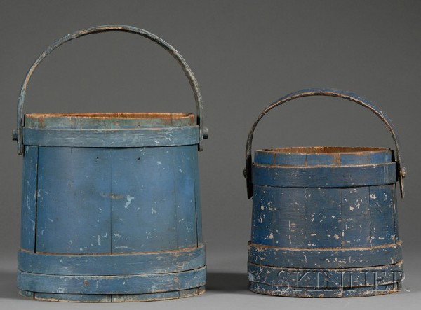 Two Blue-painted Wooden Buckets, America, 19th ce: Two Blue-painted Wooden Buckets, America, 19th century, stave and lapped hoop construction, with swing handles, (wear), ht. 9 1/2, 12 in.