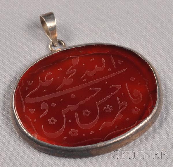Carnelian Islamic Intaglio Pendant, carved with Is: Carnelian Islamic Intaglio Pendant, carved with Islamic script, silver bezel, lg. 1 5/8 in.